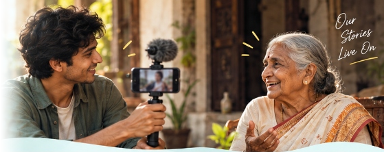 Young Indian creator recording an elder's storytelling session on smartphone with microphone and gimbal